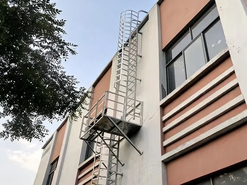 Bâtiment équipé d'une échelle de toit fixe pour l'accès aux équipements techniques de toiture